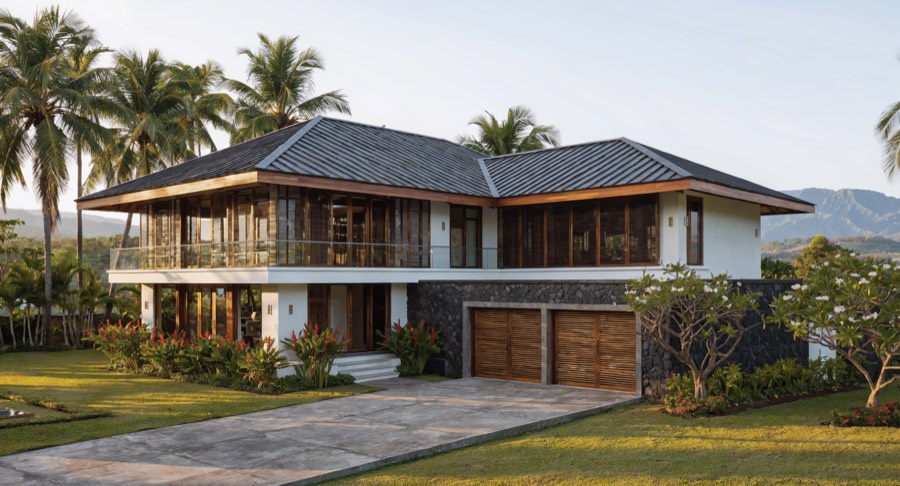 Artist's impression of the Pavilion: a contemporary two-storey house with
                  wide-eaved metal roofs, lava stone and white stucco walls, teak louvered
                  screens and an enclosed garage set into the stone plinth.